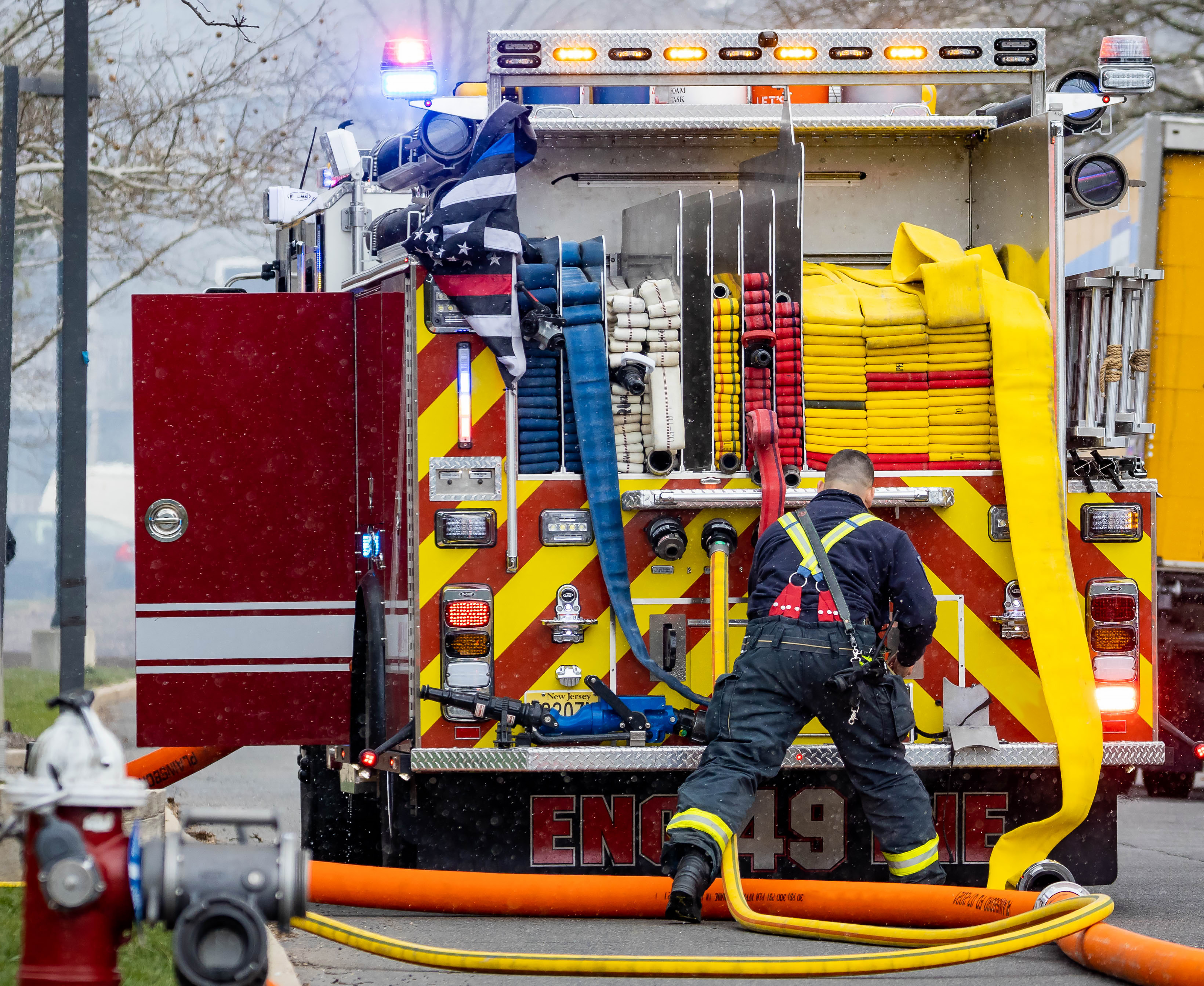 Back of the firetruck with firefighter and equipment